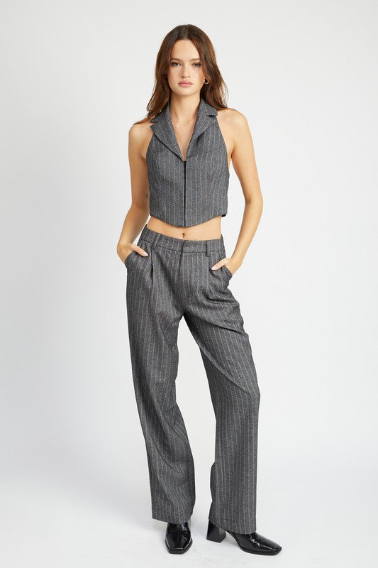 Emory Park model wearing Loose Fit Pinstripe Pants paired with matching sleeveless blazer and black shoes