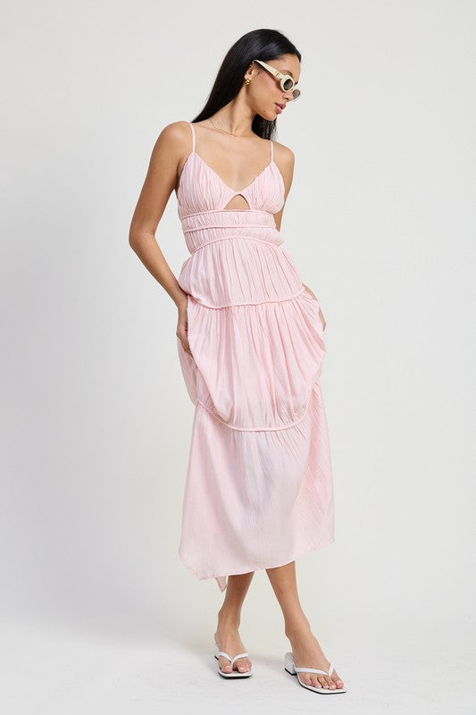 Woman wearing a light pink Emory Park Maxi Ruffle Tie Back Dress with thin straps and tiered ruffles
