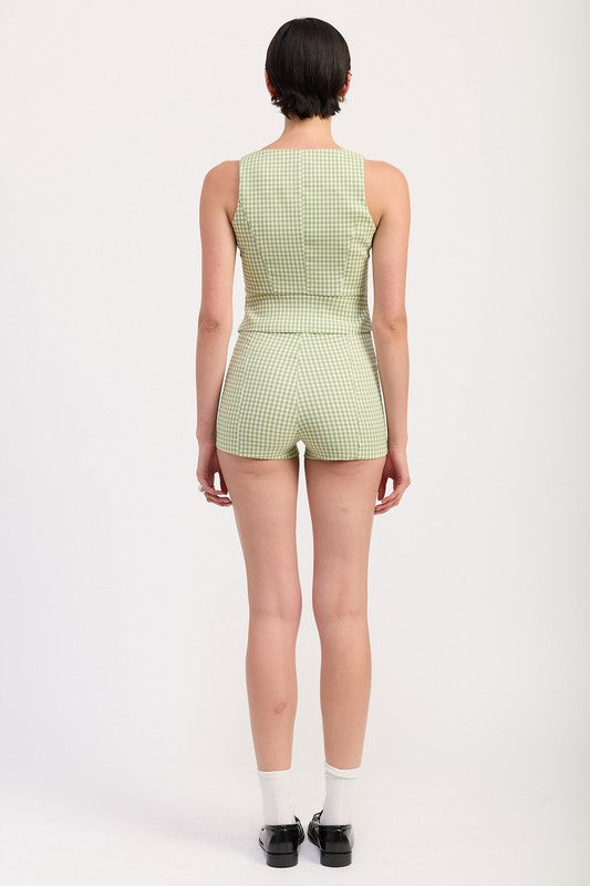 Back view of model wearing Emory Park Micro Gingham Shorts in green and white checkered pattern