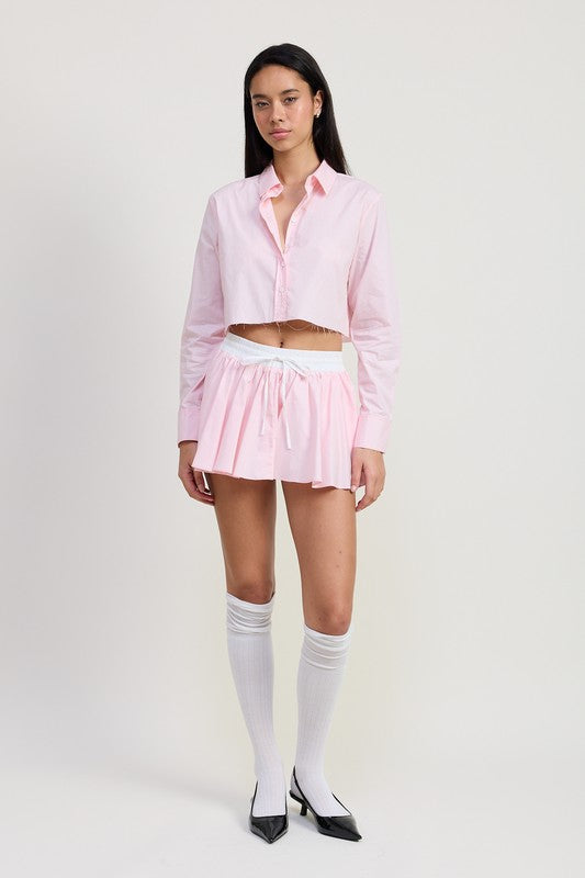 Emory Park Mini Contrast Waistband Skirt in light pink worn with a matching cropped shirt and white knee-high socks