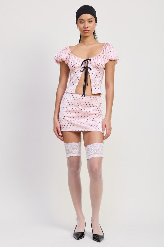 Emory Park Mini Polka Dot Skort in pink with black dots worn with matching top and lace thigh-high stockings