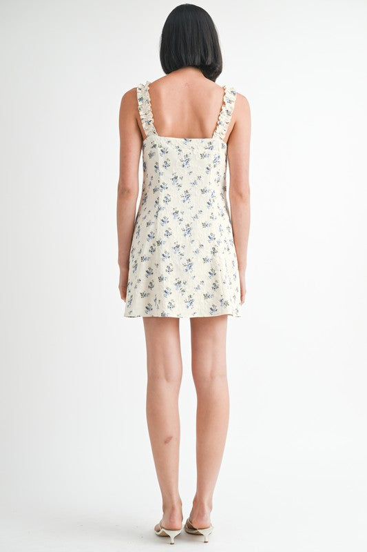 Back view of Emory Park Mini Ruffle Bow Tie Dress with floral print and ruffled straps
