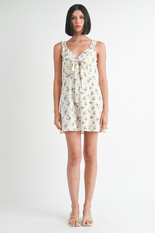 Emory Park Mini Ruffle Bow Tie Dress with floral print and ruffled straps on model