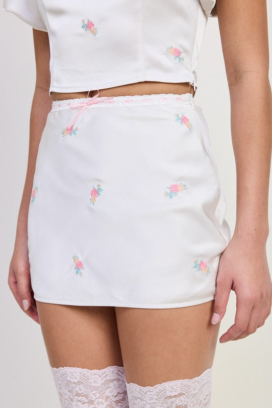 Emory Park Mini Satin Bias Skirt in white with pink floral embroidery and lace trim waist