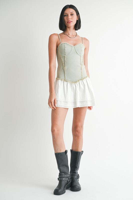 Emory Park Mini Sleeveless Denim Dress styled with white skirt and black boots on model