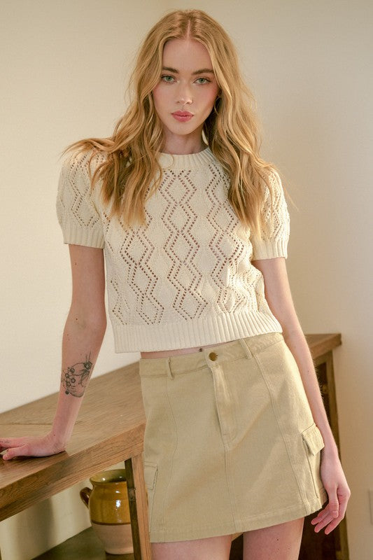 Model wearing Mittoshop Cargo Mini Skirt with Side Pockets paired with a knit sweater