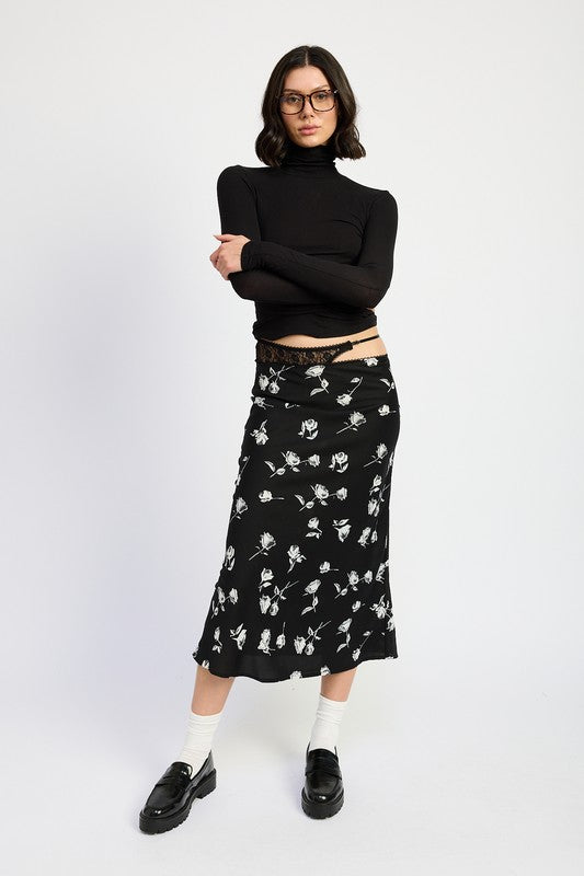 Emory Park Mixe Media Asymmetrical Maxi Satin Skirt in black with white floral print worn with black turtleneck and loafers