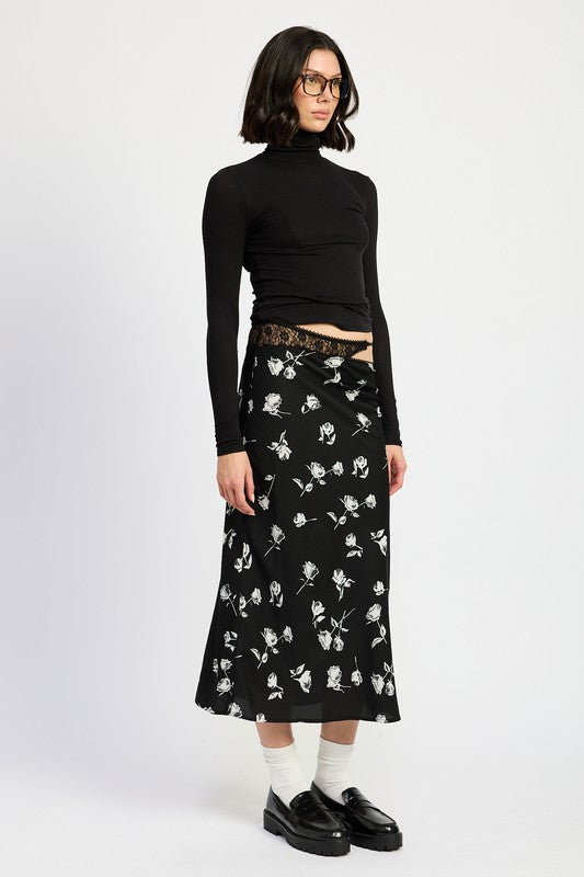 Emory Park Mixe Media Asymmetrical Maxi Satin Skirt in black with white floral print styled with black turtleneck and loafers