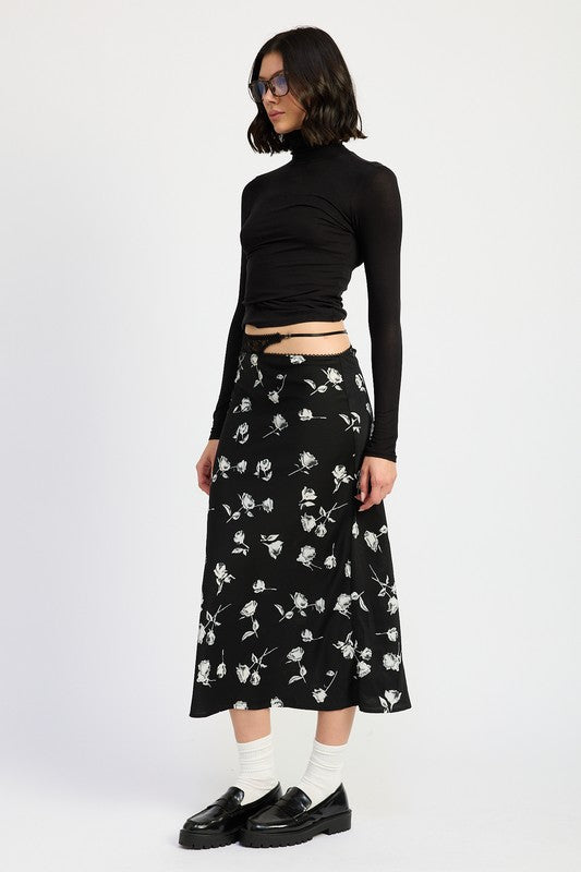 Emory Park Mixe Media Asymmetrical Maxi Satin Skirt in black with white floral print styled with black turtleneck and loafers side