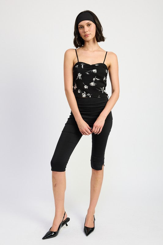 Emory Park mixed media satin spaghetti strap top with floral design worn by model with black pants