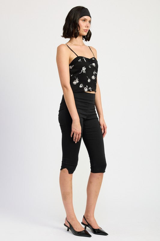 Emory Park Mixed Media Satin Spaghetti Strap Top in black with white floral print worn with black capri pants