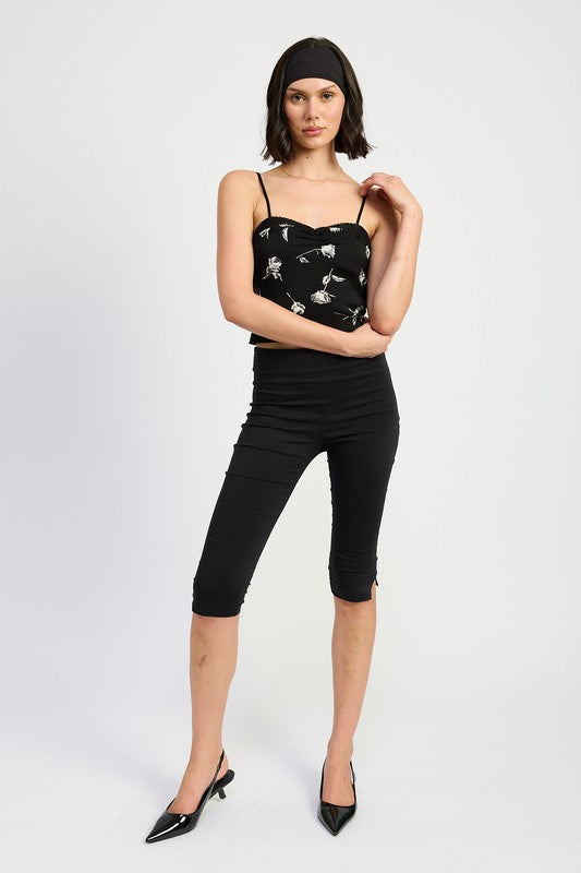 Emory Park Mixed Media Satin Spaghetti Strap Top in black floral worn with black capri pants and heels