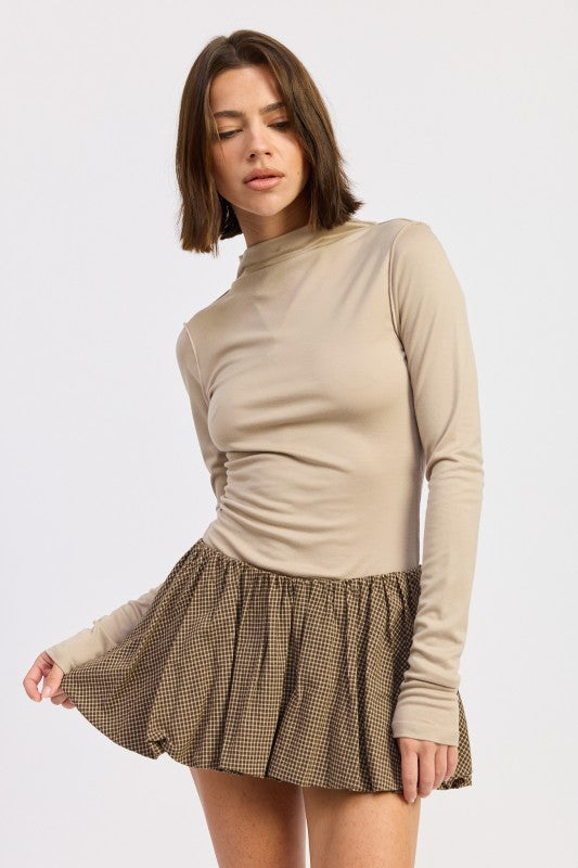 Emory Park Mock Neck Long Sleeve Jersey Latte Top paired with a checkered skirt for a trendy look