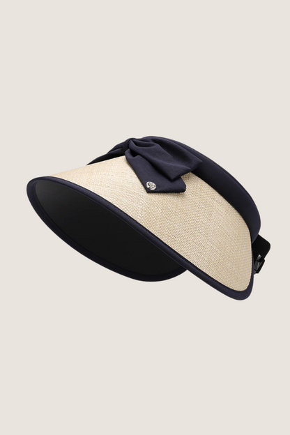Natural grass wide brim hat with navy ribbon, perfect for sunny outdoor activities