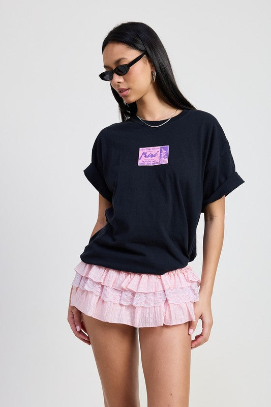 Emory Park Gingham Mini Ruffle Skort in pink with layered ruffles worn with black graphic t-shirt and sunglasses