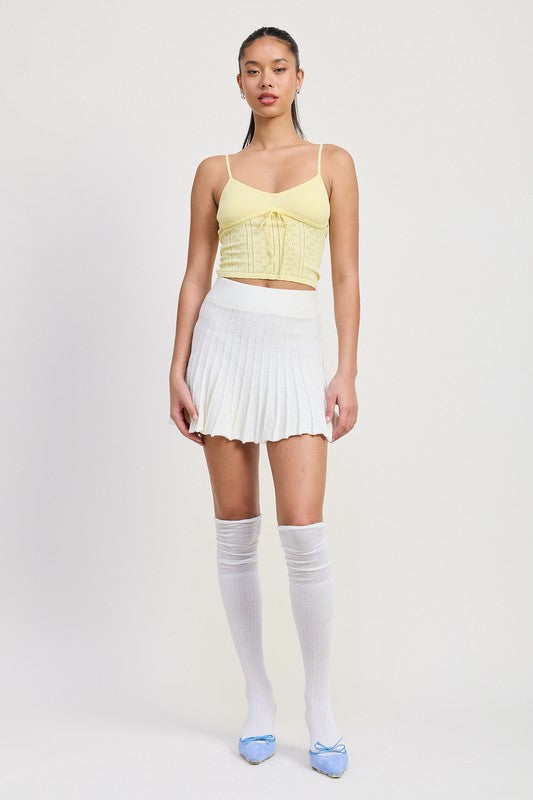 Emory Park white Pleated Mini Skirt worn with yellow crop top and knee-high white socks