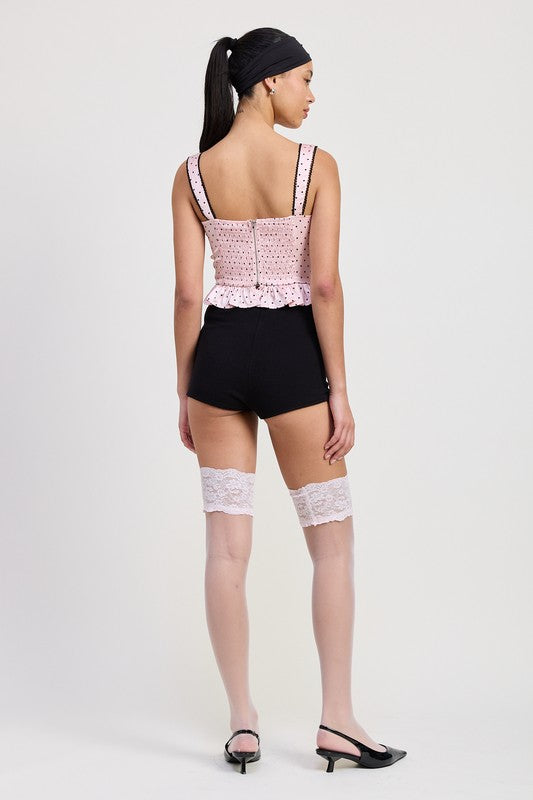 Back view of woman wearing Emory Park Polka Dot Corset Top with black shorts and lace stockings