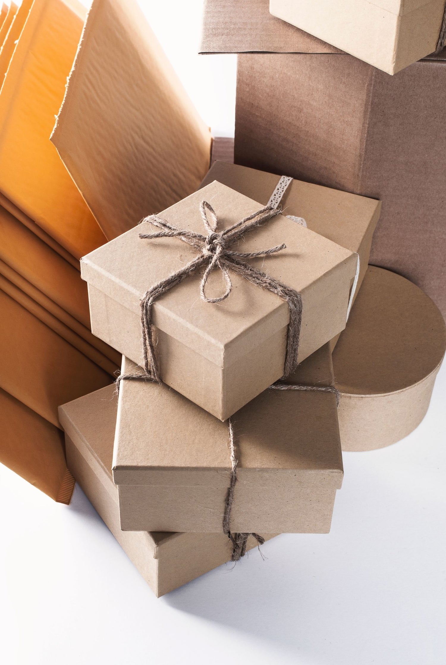 Stack of brown paper boxes with string on a white background