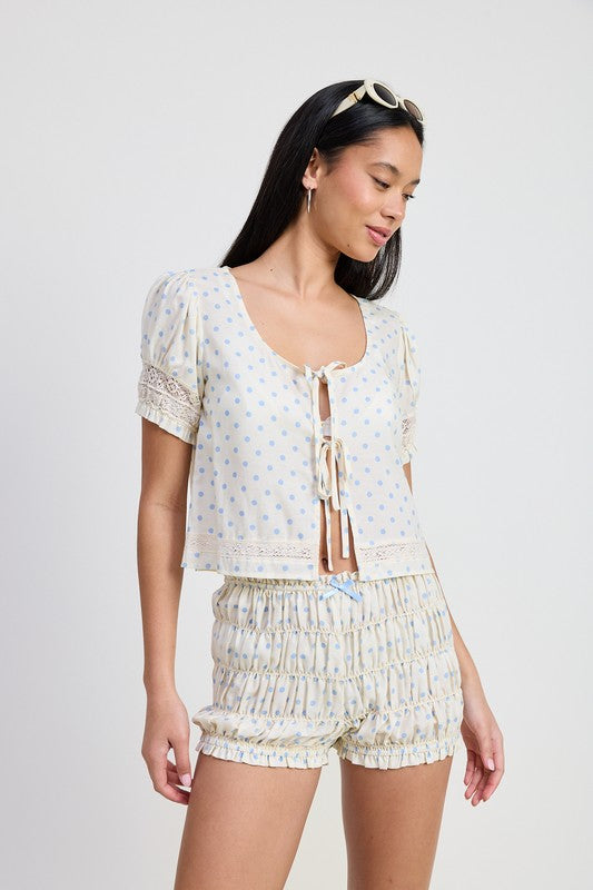 Emory Park Puff Sleeve Tie Front Top in cream with blue polka dots worn by model with matching shorts