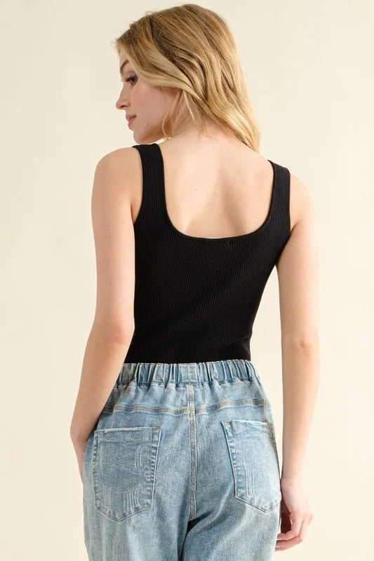 Back view of a Ribbed Tank Bodysuit in black paired with high-waisted denim shorts