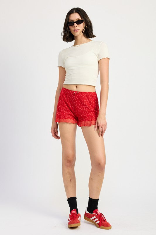 Emory Park Ruffle Jersey Shorts in red worn with white cropped top and red sneakers