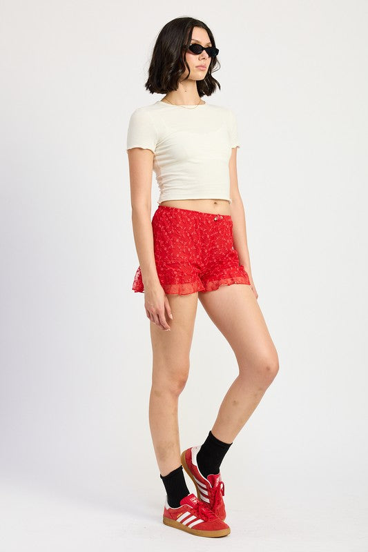 Emory Park red Ruffle Jersey Shorts worn with white crop top and red sneakers
