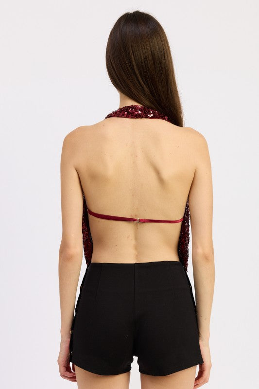 Back view of Emory Park Sequin Cowl Drape Halter Top styled with black shorts