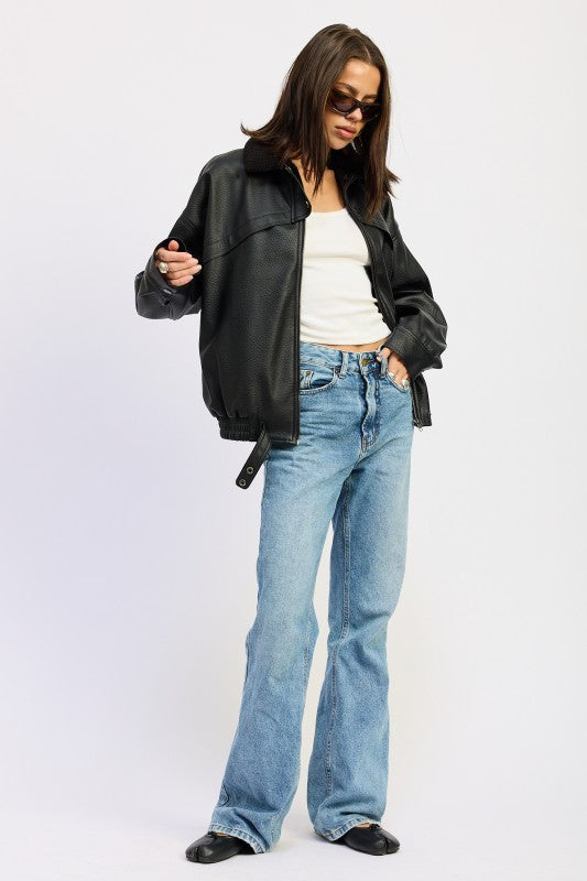 Emory Park Shearling Collar Vegan Leather Jacket in black, styled with light blue jeans for a modern look