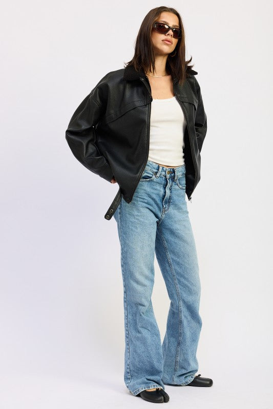 Emory Park Shearling Collar Vegan Leather Jacket in black paired with flared jeans for a stylish look