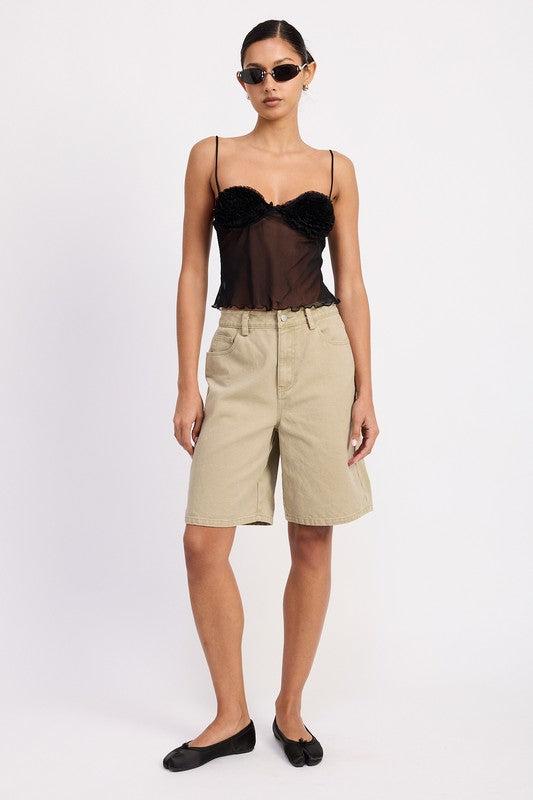 Model wearing Emory Park Sheer Mesh Floral Cup Cami Top in black with beige knee length shorts and flats