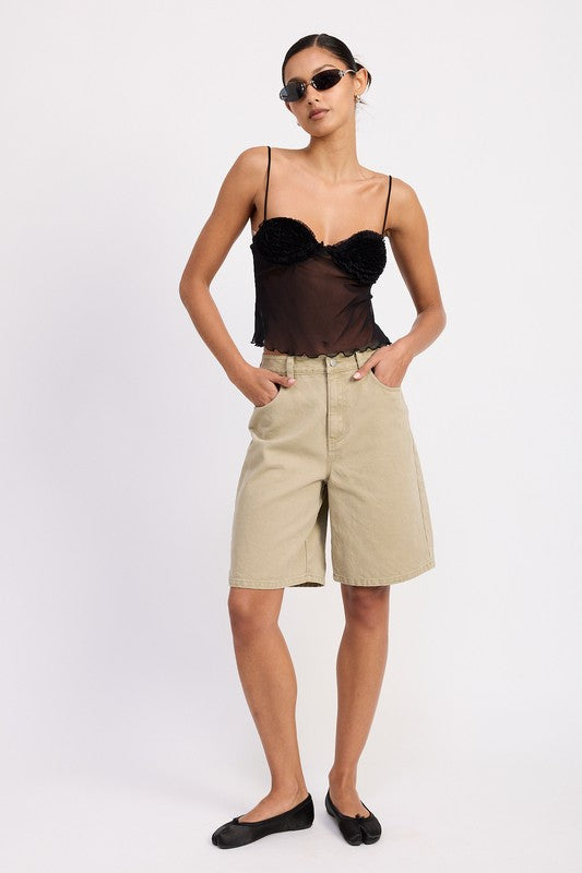 Model wearing Emory Park Sheer Mesh Floral Cup Cami Top in black with thin straps paired with khaki Bermuda shorts