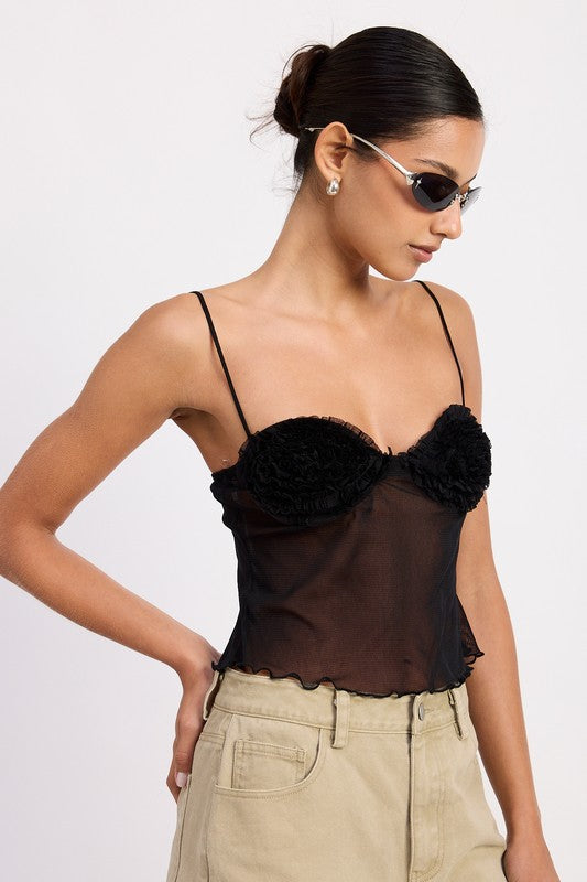 Model wearing Emory Park Sheer Mesh Floral Cup Cami Top in black with thin straps ruffled hem