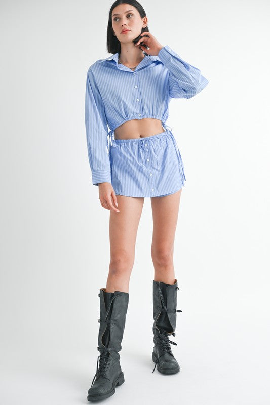 Emory Park Drawstring Mini Skort With Buttons in blue striped fabric with cropped button shirt and black boots