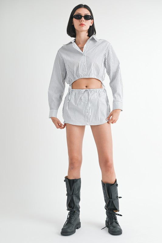 Emory Park model wearing striped Drawstring Mini Skort With Buttons and matching cropped shirt styled with black combat boots