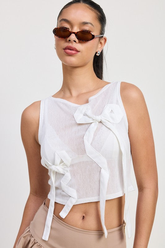 Emory Park Sleeveless Sheer Bow Top in white with decorative bow accents and sheer fabric