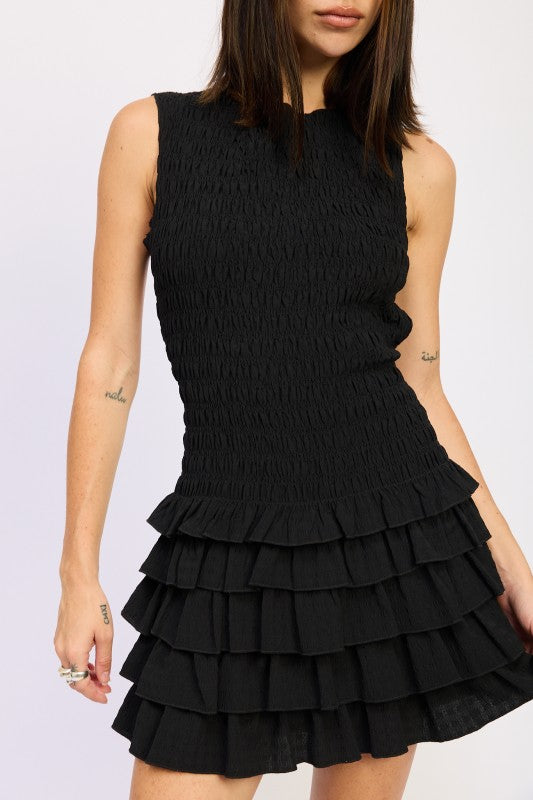 Emory Park Sleeveless Smocked Mini Dress With Ruffle in Black, featuring a fitted bodice and tiered ruffle skirt