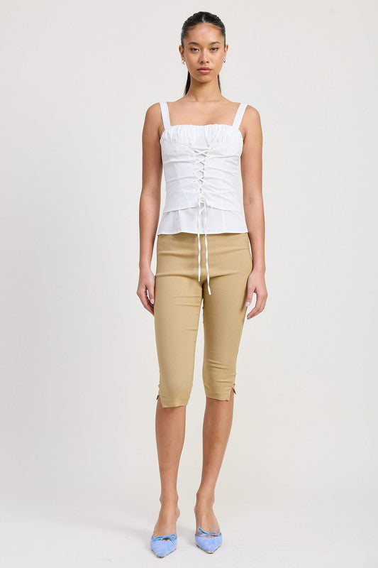 Emory Park white Square Neck Corset Top with front lace-up detail worn with beige capri pants