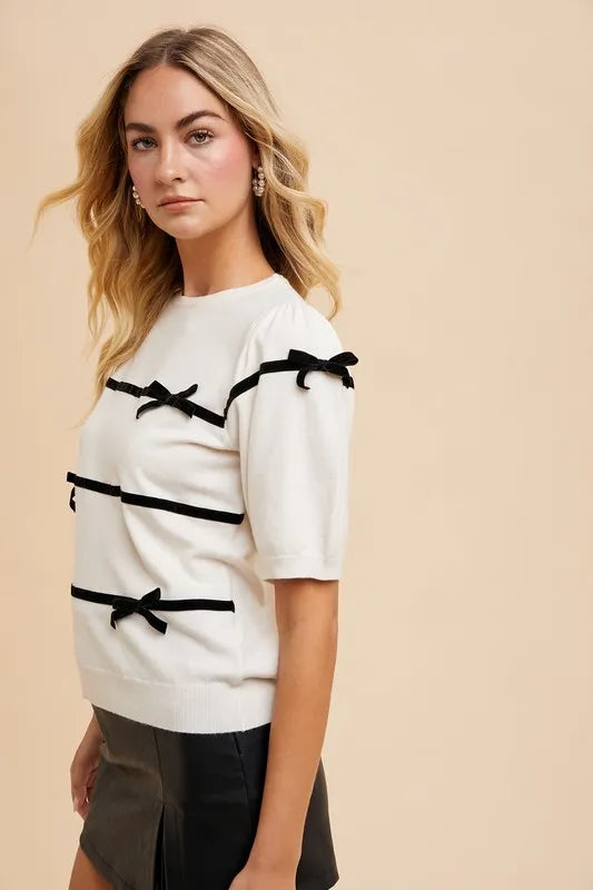Striped Bow Knit Top in cream with black bows, perfect for a stylish casual look