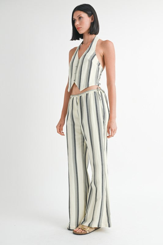 Emory Park striped straight leg pants in cream with black vertical stripes worn with matching halter top