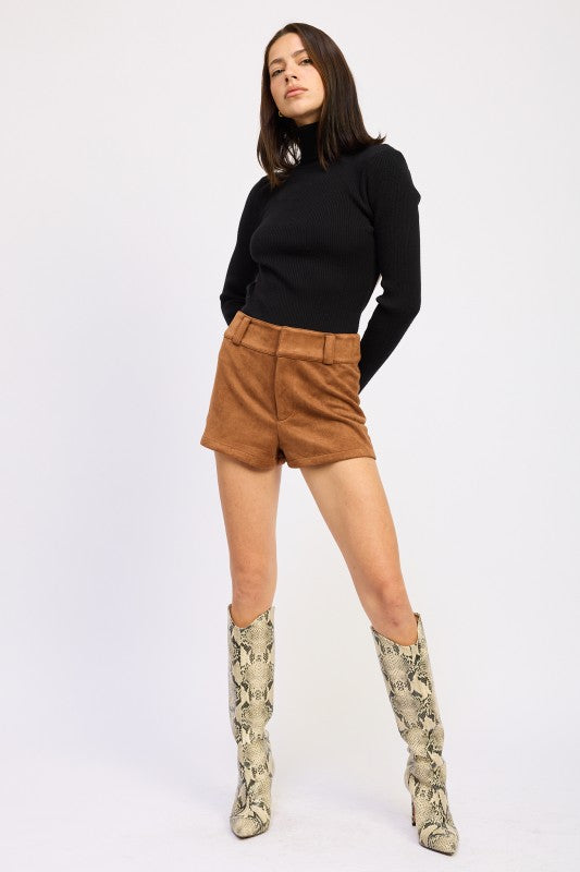 Emory Park Suede Low-Rise Shorts in brown with a stylish turtleneck and snake print boots
