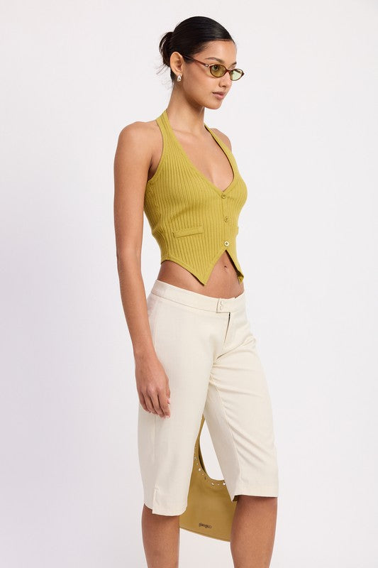 Emory Park model wearing Tailored Mid-Rise Bermuda Pants in cream with lime ribbed halter top and sunglasses