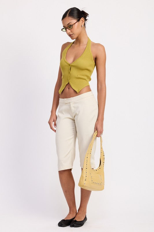 Emory Park Tailored Mid-Rise Bermuda Pants in cream worn by model with green ribbed halter top and yellow bag