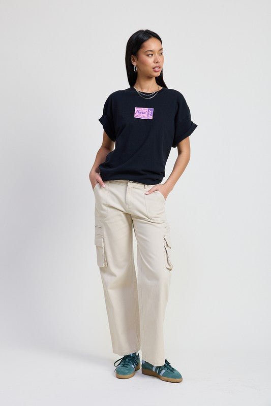 Emory Park model wearing beige Pocket Cargo Pants with side cargo pockets relaxed straight leg fit