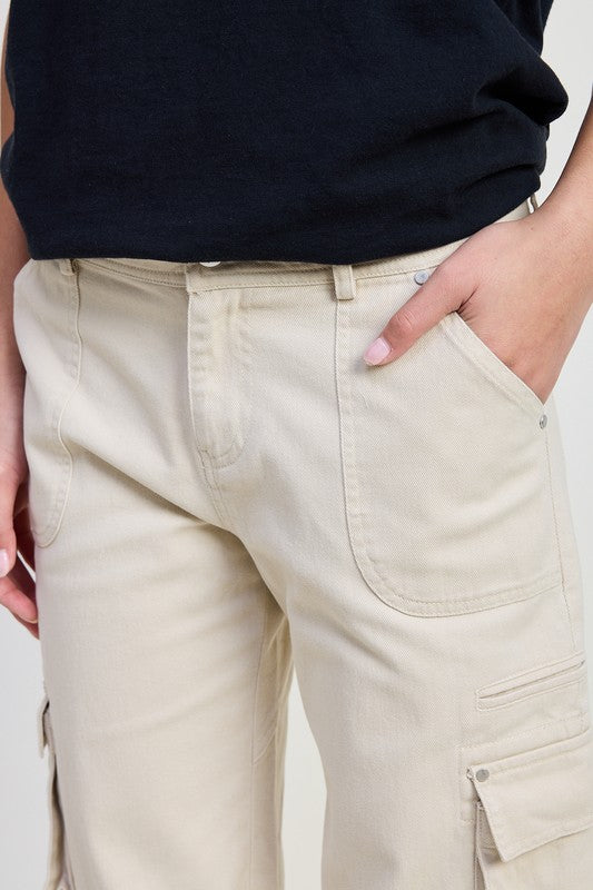 Emory Park beige Pocket Cargo Pants with front patch pockets and side flap pocket and hand resting in pocket