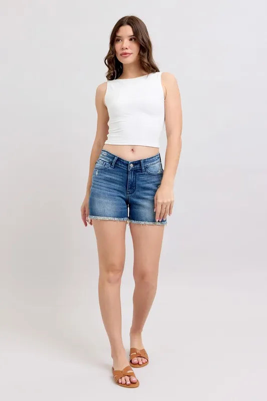 Model wearing V-Front Denim Shorts with a white crop top and sandals for a casual summer look