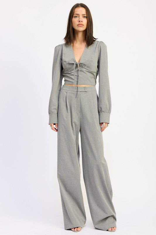 Emory Park V-Neck Cropped Blouse With Rhinestones, styled with high-waisted wide-leg trousers in a light gray color