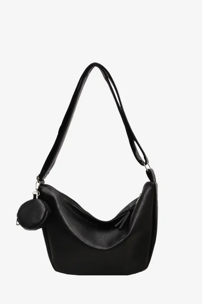 Vegan Leather Crossbody Bag in Black with a stylish curved design and matching coin purse