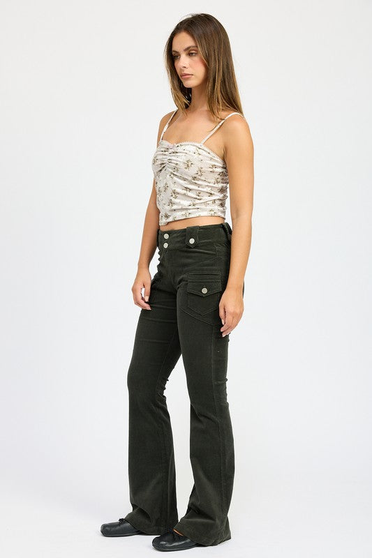 Woman wearing Emory Park Velvet Ruched Top With Lace Detail and black high-waisted pants