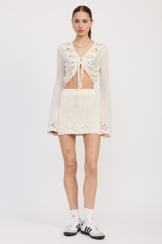 Emory Park Lettuce Hem Mini Crochet Skirt in white worn with matching crochet top and sneakers front