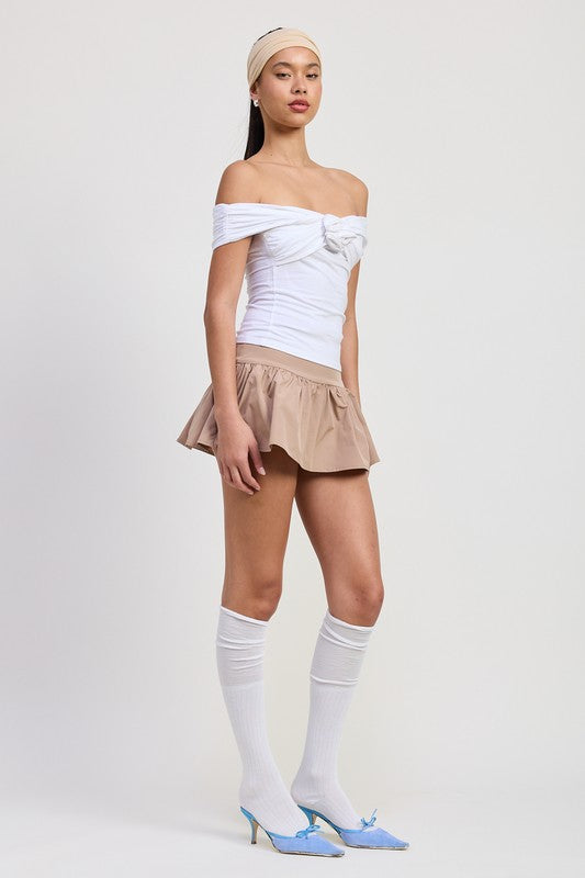 Emory Park Off Shoulder Rosette Top in white worn by model with beige skirt and blue heels